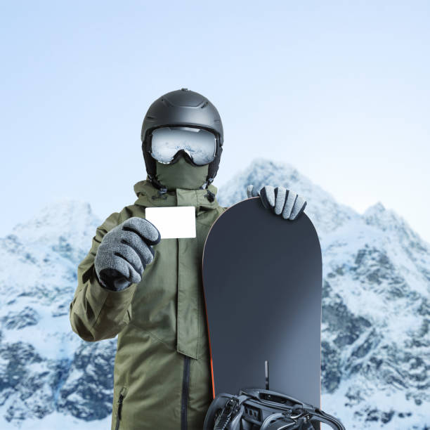istock Young snowboarder holding blank lift pass with mountain on background 674990894