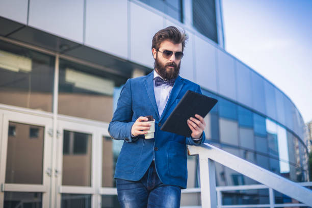 istock Elegant businessman using digital tablet during the coffee break 674991000