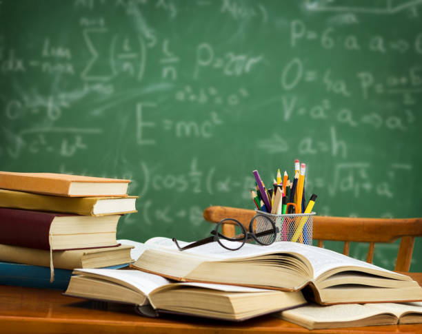 istock glasses on pile of books 674991260