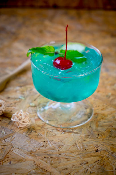 istock Blue Hawaiian lime soda on wooden table 674995126