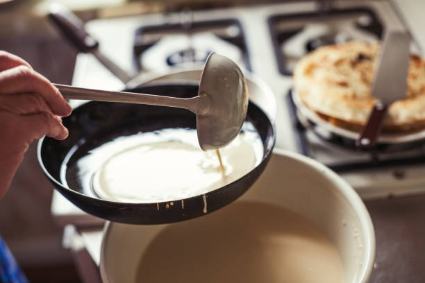 Grandmother making pancakes Grandmother making pancakes crêpe pancake stock pictures, royalty-free photos & images