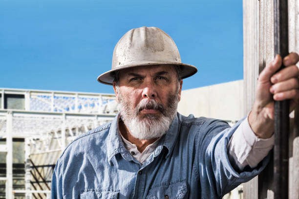 istock Male construction worker with serious look on job site 674997968