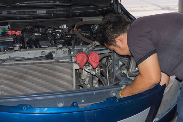 istock Serviceman checking a car for fix and repair at garage 674998220