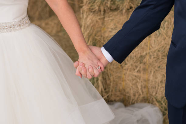 istock Bride and Groom Holding Hands 675003262