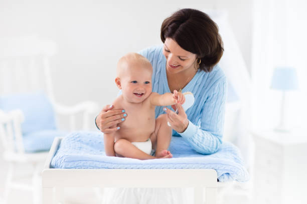 istock Mother changing diaper to baby boy 675003550