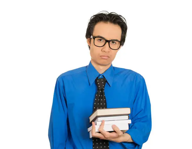 Photo of worried stressed unhappy student with big black glasses standing holding books