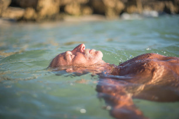 Young man relaxing and refreshing in the ocean