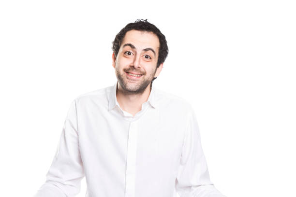 A man who wears white shirt looking to camera with a puzzled but positive face
