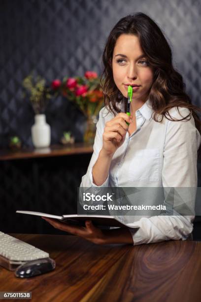 Creative Businesswoman Writing On Planner Stock Photo - Download Image Now - Contemplation, Editor, Writing - Activity