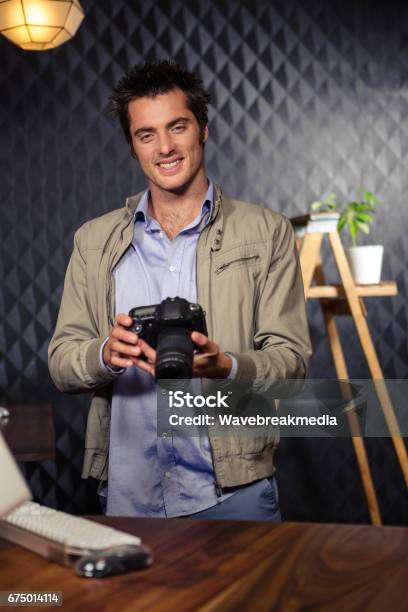 Creative Businessman Looking At Picture On Camera Stock Photo - Download Image Now - 20-24 Years, 20-29 Years, Adult