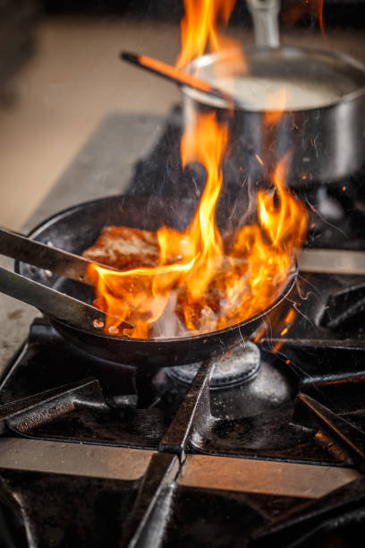 istock Chef frying pork meat 675020760