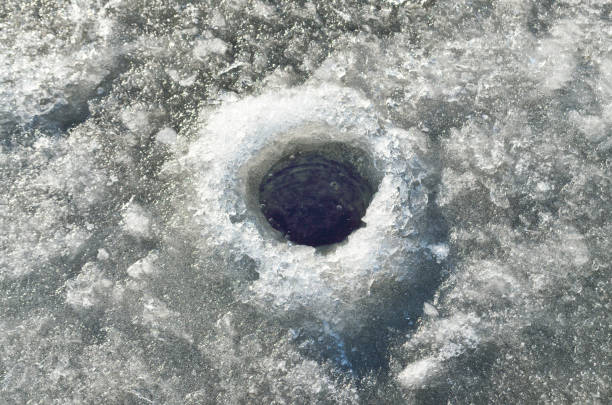 istock The hole is drilled in the ice. 675021492