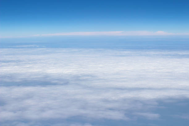 istock blue sky high view from airplane clouds shapes 675026890