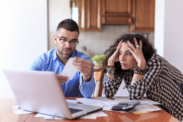 istock Couple calculating bills at home 675035652