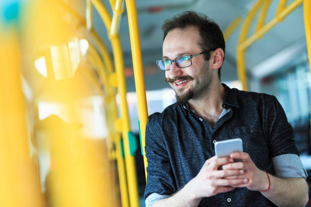 istock Young man traveling with bus and using smart phone 675035670