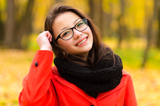 autumn portrait Korean girl smiling in glasses outdoors