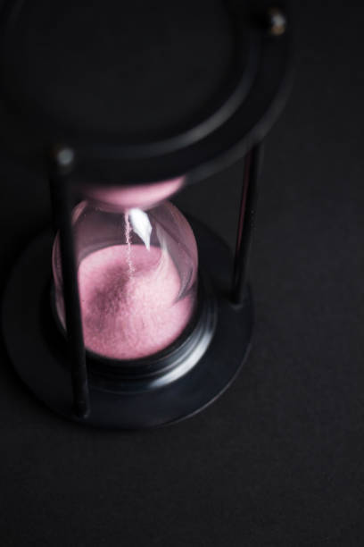 istock Large black hourglass against a black background 675036544