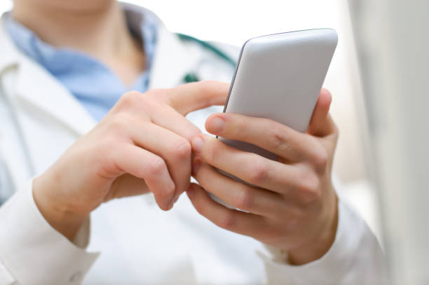 istock A female doctor texting on smartphone 675047600