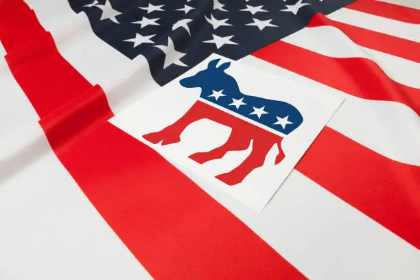 Photo of Series of USA ruffled flags with democratic party symbol over it