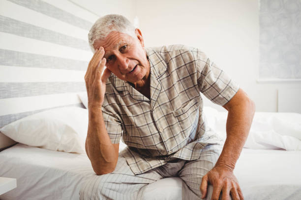 istock Frustrated senior man sitting on bed 675049280