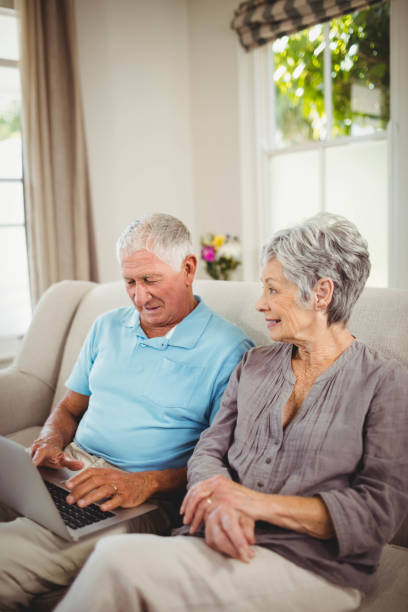 istock Senior couple looking at laptop 675049446