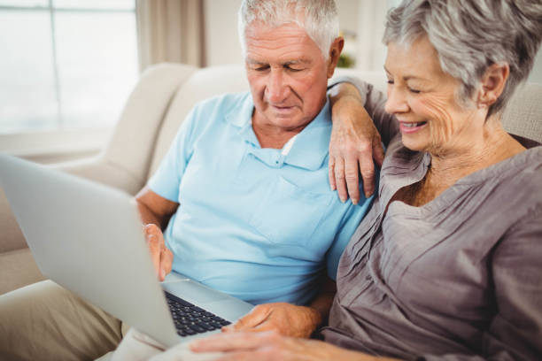 istock Senior couple looking at laptop 675049470
