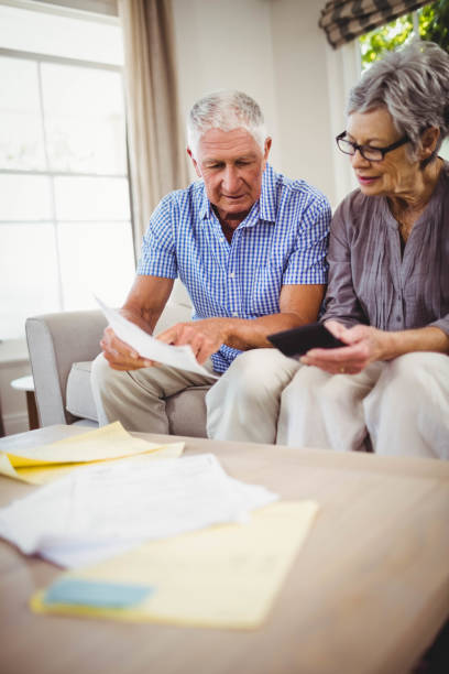 istock Senior man showing documents to woman 675052114