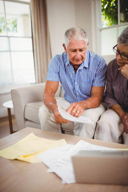 istock Senior man showing documents to woman 675052208