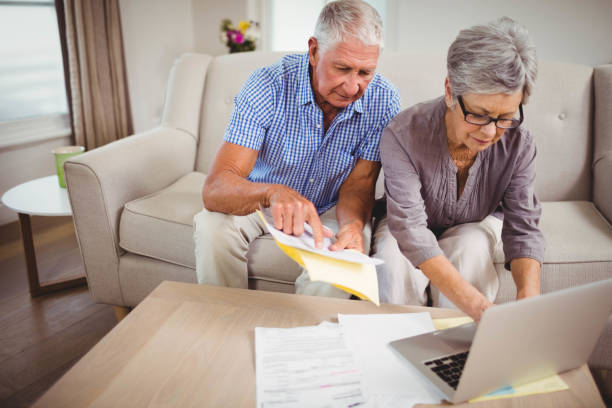 istock Senior woman paying bills online on laptop 675052272