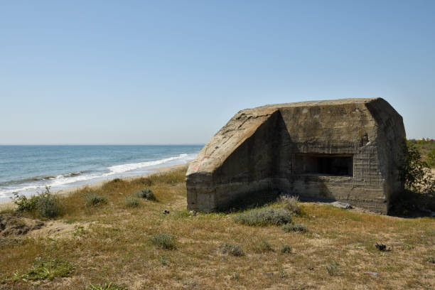 istock Foxhole on the beach with sea and blue sky in background 675052346