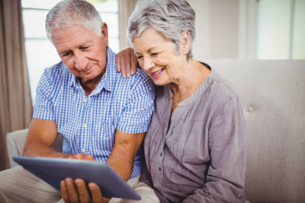 Senior couple looking at digital tablet