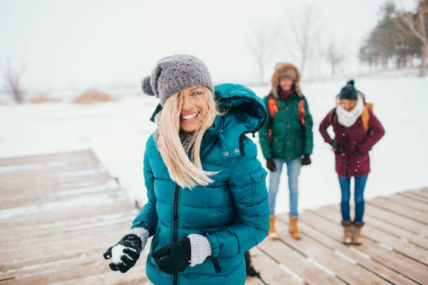 Snowball fight Friends having fun in a winter day winter coat stock pictures, royalty-free photos & images