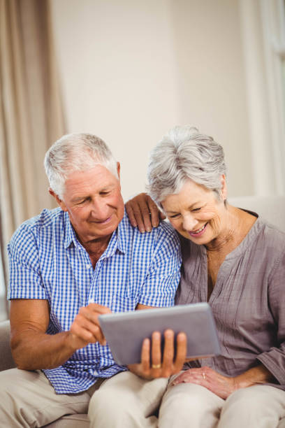 istock Senior couple looking at digital tablet 675054778