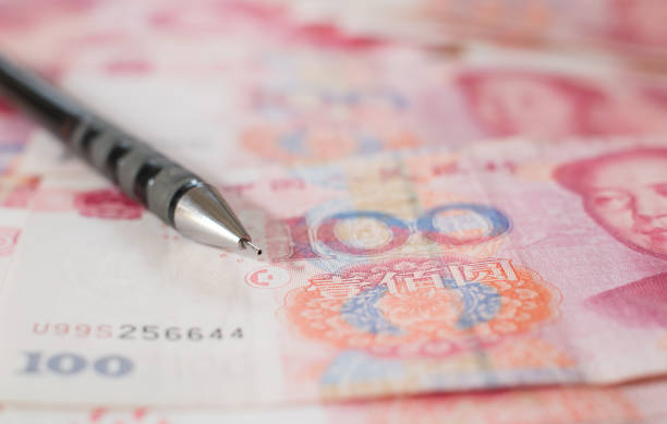 istock Chinese Yuan bank notes currency with a pencil 675059182