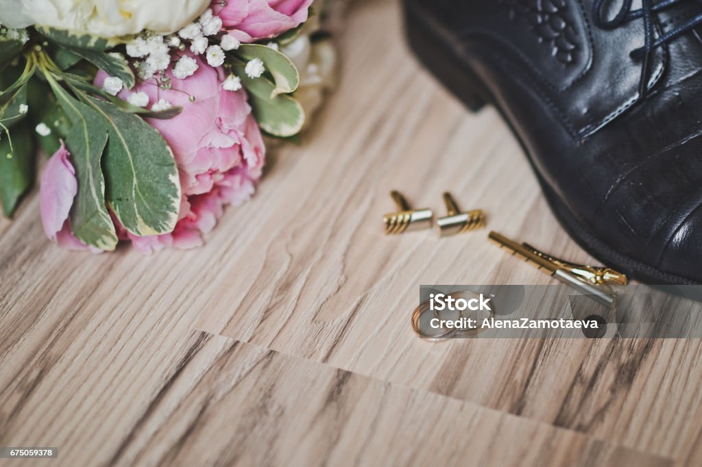 Accessories for the wedding ceremony 7430. Wedding ring on the floor surrounded by flowers and shoes. Arts Culture and Entertainment Stock Photo