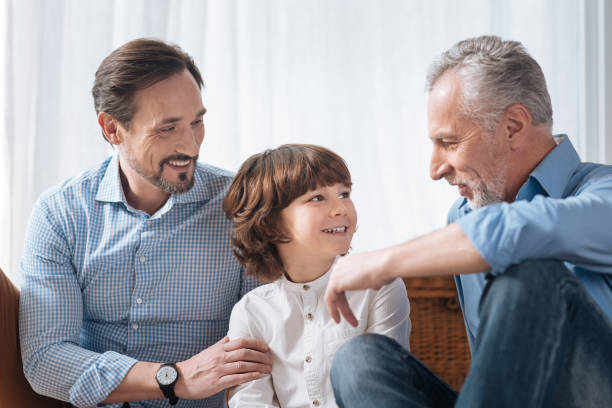 istock Handsome delighted grandfather looking at his grandson 675060180