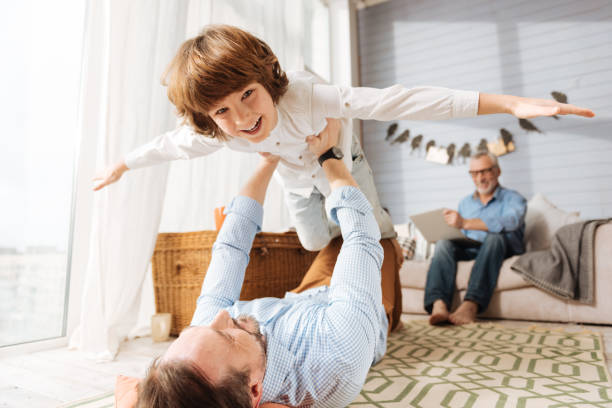 istock Happy cute boy being held by his father 675060518