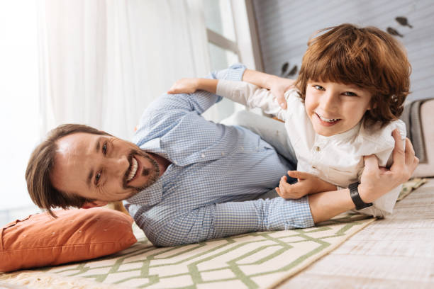istock Joyful happy father and son lying on the floor 675060556