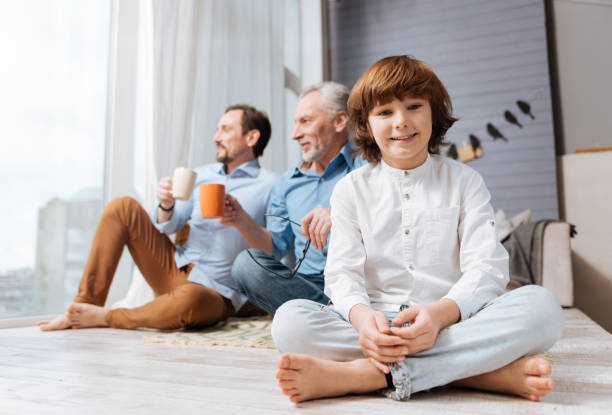 istock Cute smiling boy sitting cross legged 675060918