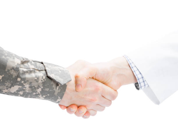 istock Doctor and military man shaking hands on white background 675062096