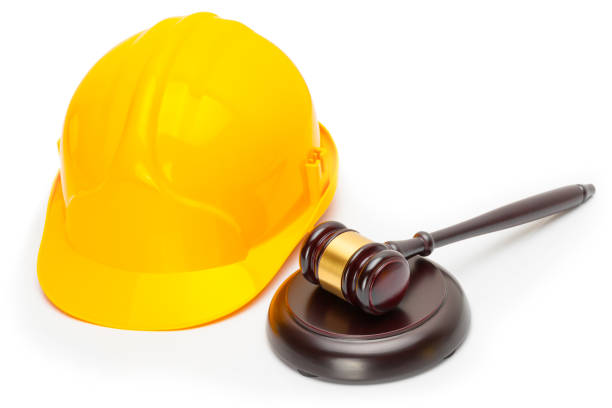 istock Wooden judge gavel with yellow protective helmet - studio shoot 675062388