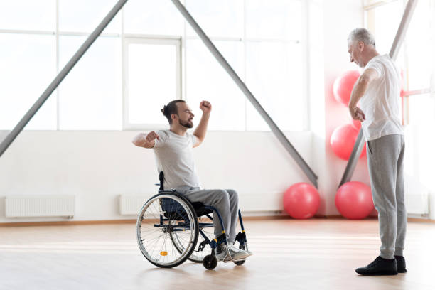 istock Involved young disabled patient training with the orthopedist 675063008