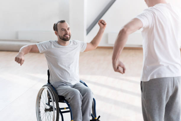 istock Charming young disabled patient training in the gym 675063056