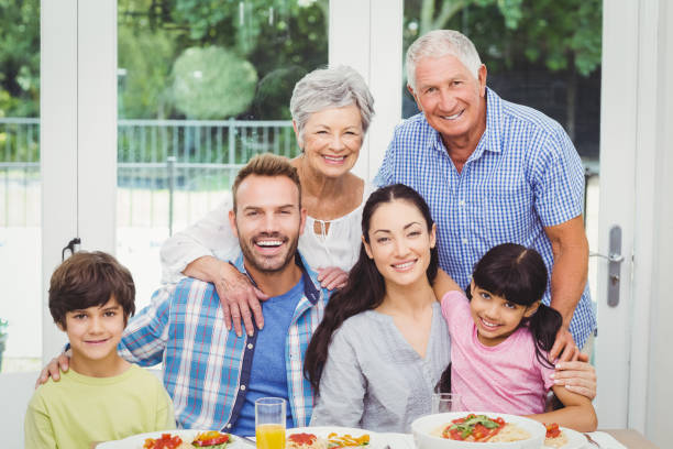istock Portrait of smiling multi generation family at dining table 675064018