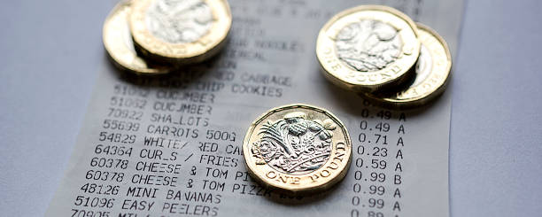 One pound coin on a till receipt. stock photo