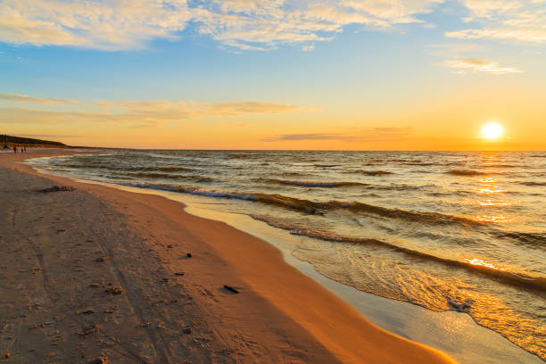 istock Sunset over sandy beach in Leba, Baltic Sea, Poland 675065488