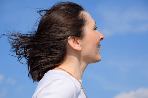 istock Girl in a white sweater on a blue sky background. 675066798