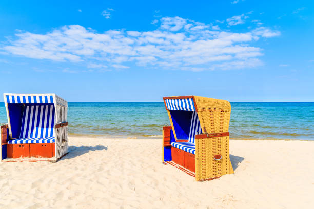 istock Colourful wicker chairs on sandy Jurata beach, Baltic Sea, Poland 675067146