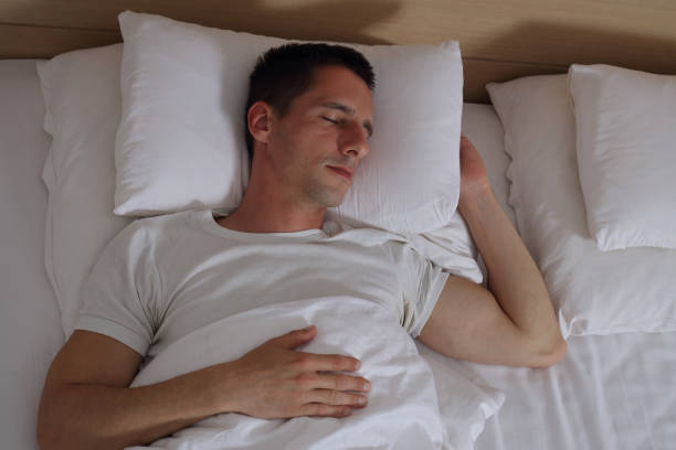 istock Young handsome man sleeping comfortably in bed. 675068878