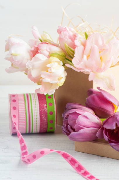 istock Fresh pink tulip flowers in gift kraft box 675069978